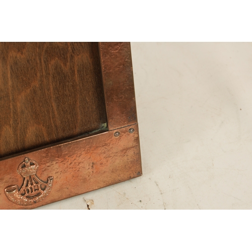 543 - AN ARTS AND CRAFTS COPPER FRAMED PICTURE FRAME IN THE LIBERTYS STYLE bearing military motif. (36.5cm... 
