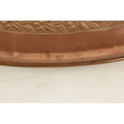 550 - AN ARTS AND CRAFTS OVAL PLENISHED COPPER TRAY with leaf and berry engraved inner border. (51cm wide ... 