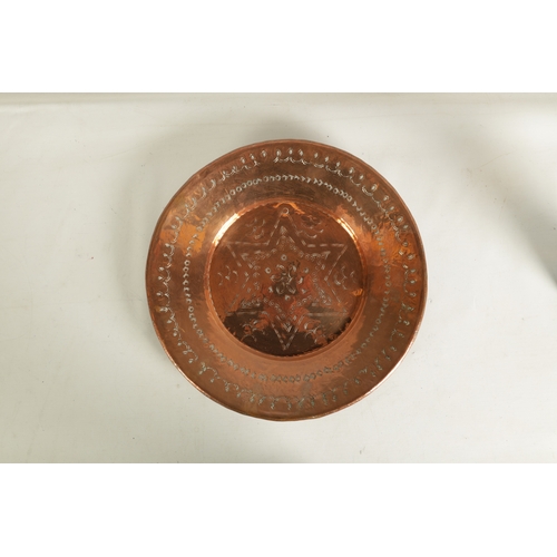 552 - AN ARTS AND CRAFTS HAMMERED COPPER HANGING CHARGER with geometric banded border and flower head star... 
