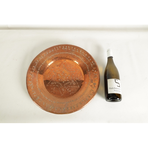 552 - AN ARTS AND CRAFTS HAMMERED COPPER HANGING CHARGER with geometric banded border and flower head star... 