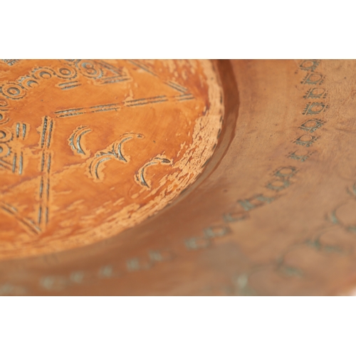 552 - AN ARTS AND CRAFTS HAMMERED COPPER HANGING CHARGER with geometric banded border and flower head star... 