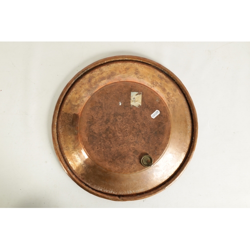 552 - AN ARTS AND CRAFTS HAMMERED COPPER HANGING CHARGER with geometric banded border and flower head star... 