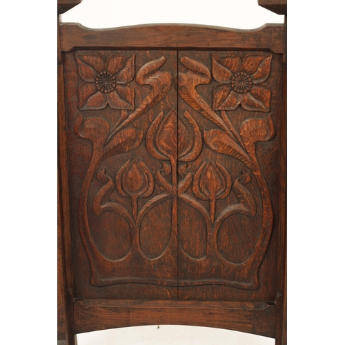 553 - A CARVED OAK ART NOUVEAU STYLE FIRE SCREEN with tulip carved panel raised on tapering side supports.... 
