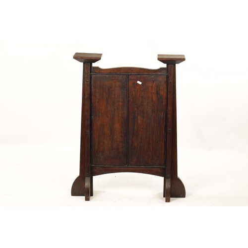553 - A CARVED OAK ART NOUVEAU STYLE FIRE SCREEN with tulip carved panel raised on tapering side supports.... 