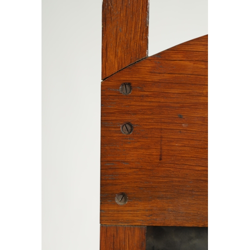 555 - AN ARTS AND CRAFTS PRESSED BRASS AND OAK FIRE SCREEN with pierced love heart decoration and angled f... 