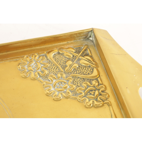 558 - AN STYLISH ARTS AND CRAFTS BRASS RECTANGULAR TRAY with shaped handles to the side and embossed flowe... 