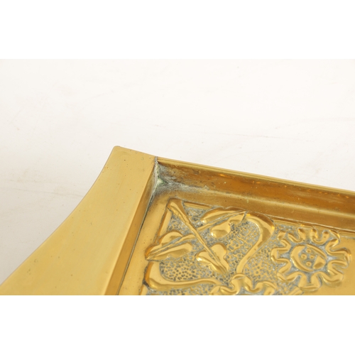 558 - AN STYLISH ARTS AND CRAFTS BRASS RECTANGULAR TRAY with shaped handles to the side and embossed flowe... 