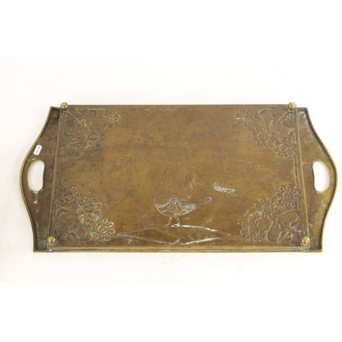 558 - AN STYLISH ARTS AND CRAFTS BRASS RECTANGULAR TRAY with shaped handles to the side and embossed flowe... 