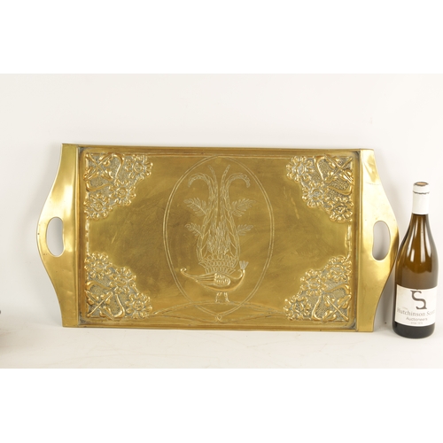 558 - AN STYLISH ARTS AND CRAFTS BRASS RECTANGULAR TRAY with shaped handles to the side and embossed flowe... 