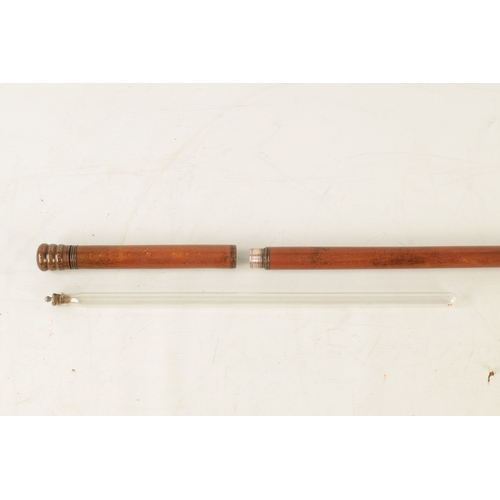 564 - A LATE 19TH CENTURY DECANTER WALKING STICK WITH SCREW OFF HANDLE with copper mounts revealing a elon... 