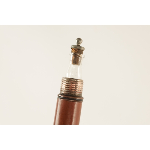 564 - A LATE 19TH CENTURY DECANTER WALKING STICK WITH SCREW OFF HANDLE with copper mounts revealing a elon... 