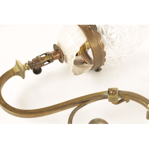 589 - A PAIR OF ELECTRIFIED BRASS WALL LIGHTS with scrolled arms and cut glass pendant shades on brass fit... 