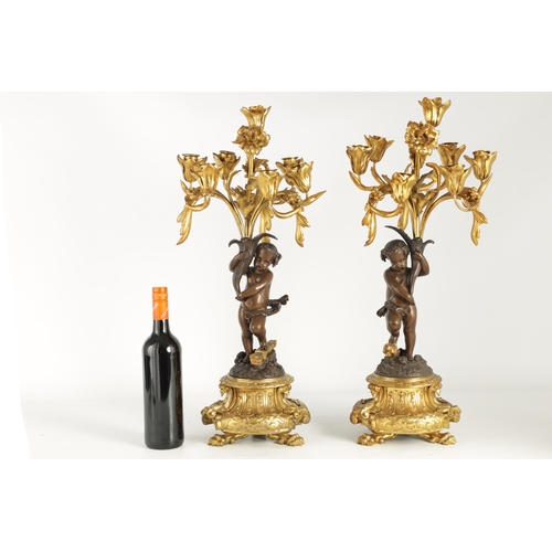 591 - A PAIR OF 19TH CENTURY BRONZE AND ORMOLU SEVEN BRANCH CANDLELARBRA with leaf and flower head decorat... 