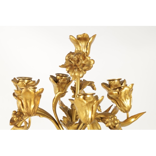 591 - A PAIR OF 19TH CENTURY BRONZE AND ORMOLU SEVEN BRANCH CANDLELARBRA with leaf and flower head decorat... 