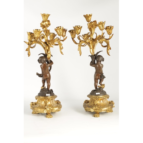 591 - A PAIR OF 19TH CENTURY BRONZE AND ORMOLU SEVEN BRANCH CANDLELARBRA with leaf and flower head decorat... 