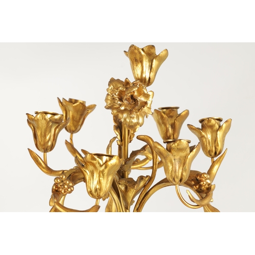 591 - A PAIR OF 19TH CENTURY BRONZE AND ORMOLU SEVEN BRANCH CANDLELARBRA with leaf and flower head decorat... 