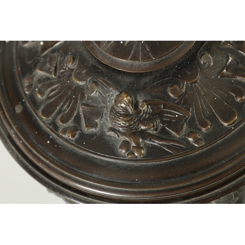 593 - A 19TH CENTURY BRONZE LIDDED TAZZA with figural finial and stylised floral decoration, raised on a g... 