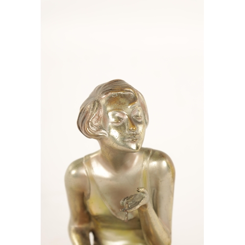 595 - ATT. JOSEF LORENZL. AN ART DECO SILVERED BRONZE FIGURAL INKSTAND modelled as a smoking girl seated o... 