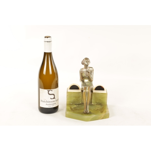 595 - ATT. JOSEF LORENZL. AN ART DECO SILVERED BRONZE FIGURAL INKSTAND modelled as a smoking girl seated o... 