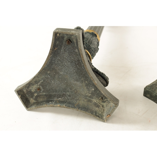 596 - A PAIR OF REGENCY-PATINATED METAL AND BRASS ORMOLU CANDLESTICKS with tapering reeded stems, leaf cas... 