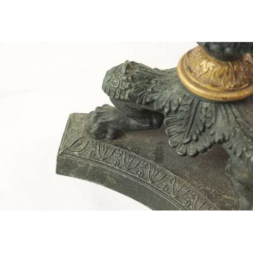 596 - A PAIR OF REGENCY-PATINATED METAL AND BRASS ORMOLU CANDLESTICKS with tapering reeded stems, leaf cas... 