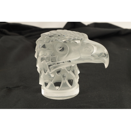 3 - A RENE LALIQUE 'TETE D'AIGLE' CLEAR AND FROSTED GLASS CAR MASCOT on a circular base moulded signatur... 