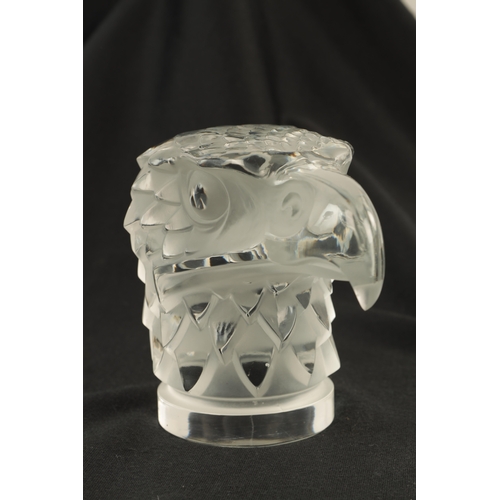 3 - A RENE LALIQUE 'TETE D'AIGLE' CLEAR AND FROSTED GLASS CAR MASCOT on a circular base moulded signatur... 