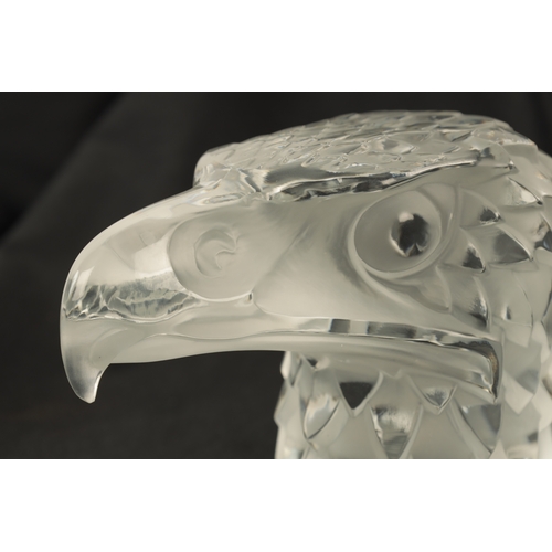 3 - A RENE LALIQUE 'TETE D'AIGLE' CLEAR AND FROSTED GLASS CAR MASCOT on a circular base moulded signatur... 