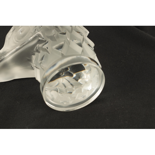 3 - A RENE LALIQUE 'TETE D'AIGLE' CLEAR AND FROSTED GLASS CAR MASCOT on a circular base moulded signatur... 