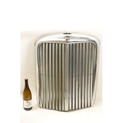 32 - A VINTAGE JAGUAR 3 1/2 LITRE CHROMED RADIATOR GRILL with black enamelled badges. (60cm wide, 68cm hi... 