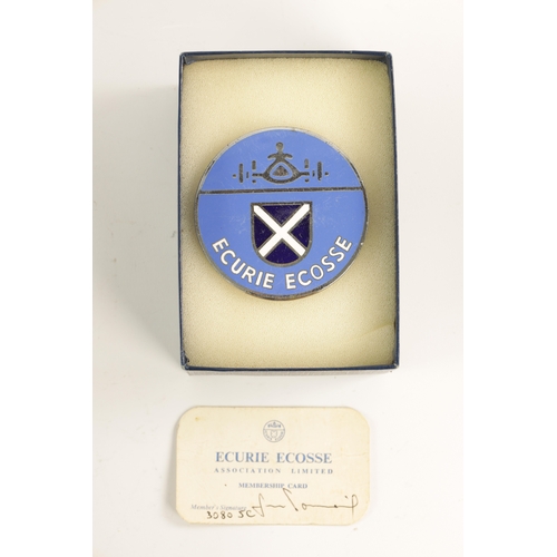 63 - AN ECURIE ECOSSE ENAMEL BUMPER BADGE with membership card number L/74 (8cm wide)