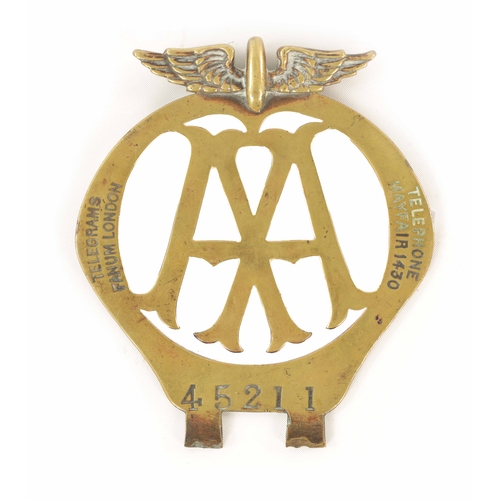 64 - AN EARLY AA BRASS CAR BADGE with winged crest. (12.5cm high)