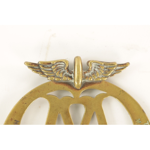 64 - AN EARLY AA BRASS CAR BADGE with winged crest. (12.5cm high)