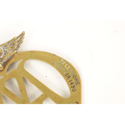 64 - AN EARLY AA BRASS CAR BADGE with winged crest. (12.5cm high)