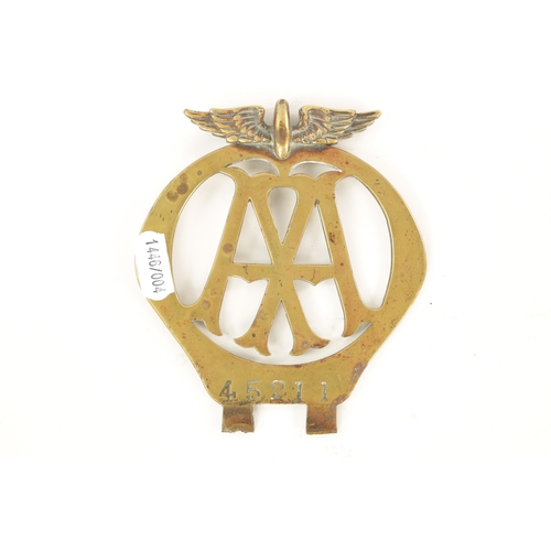 64 - AN EARLY AA BRASS CAR BADGE with winged crest. (12.5cm high)