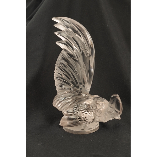 7 - A RENE LALIQUE 'COQ NAIN' CLEAR GLASS AND FROSTED CAR MASCOT on a circular base engraved 'FRANCE' an... 