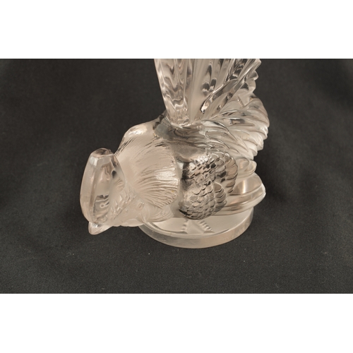 7 - A RENE LALIQUE 'COQ NAIN' CLEAR GLASS AND FROSTED CAR MASCOT on a circular base engraved 'FRANCE' an... 