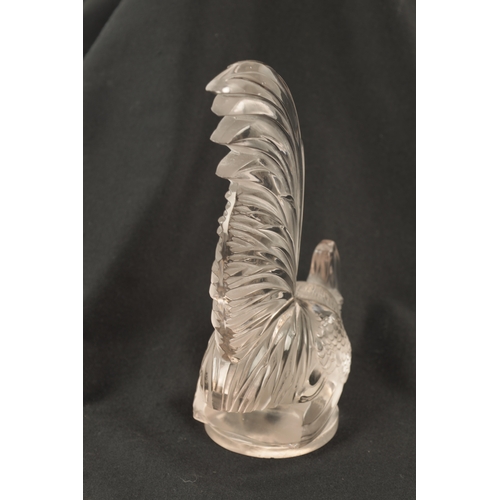 7 - A RENE LALIQUE 'COQ NAIN' CLEAR GLASS AND FROSTED CAR MASCOT on a circular base engraved 'FRANCE' an... 