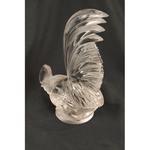 7 - A RENE LALIQUE 'COQ NAIN' CLEAR GLASS AND FROSTED CAR MASCOT on a circular base engraved 'FRANCE' an... 