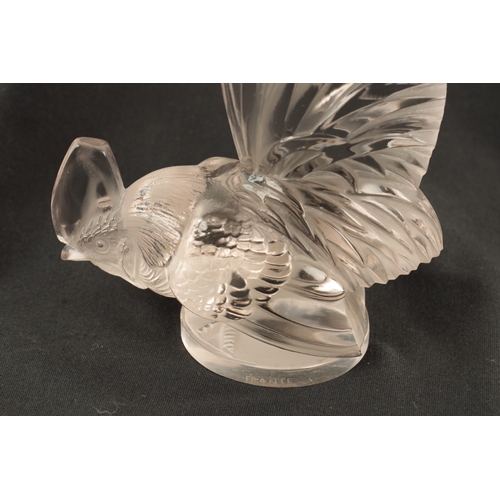 7 - A RENE LALIQUE 'COQ NAIN' CLEAR GLASS AND FROSTED CAR MASCOT on a circular base engraved 'FRANCE' an... 