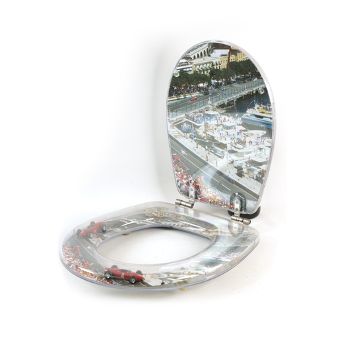 79 - A FERRARI-THEMED TOILET SEAT with Monaco backdrop containing 4 model Ferraris - bearing plaques 'ELI... 