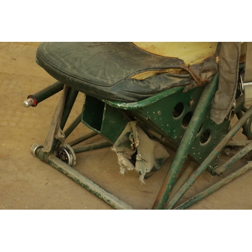 85 - AN EARLY AIRCRAFT LEATHER UPHOLSTERED PILOTS SEAT with adjustable armrests and green steel frame. (1... 