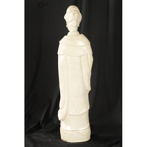 100 - A 19TH CENTURY CHINESE ‘BLANC DI CHINE’ STANDING FIGURE OF A GUAN modelled in flowing robes holding ... 