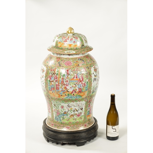 102 - A LARGE 19TH CENTURY CANTONESE FAMILLE ROSE VASE AND COVER of baluster form with decorated panels de... 