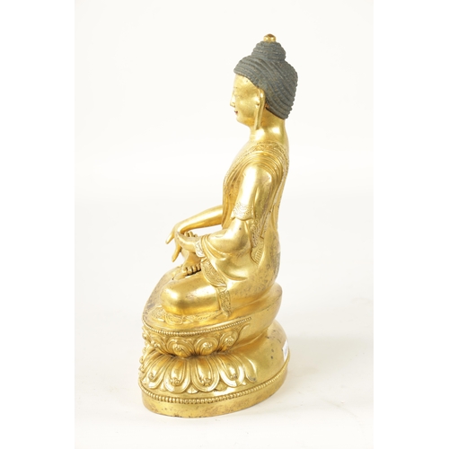 105 - AN EARLY CAST GILT BRONZE TIBETAN BUDDHA seated on a shaped leaf work base. (29cm high )