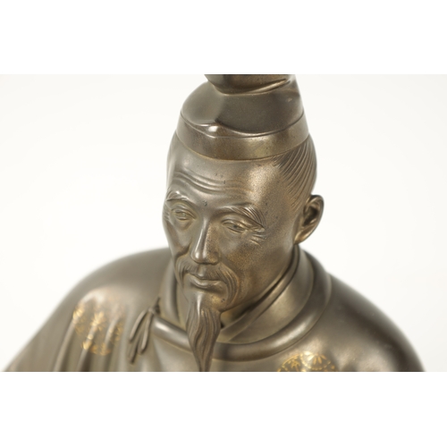 106 - A FINE JAPANESE MEIJI PERIOD BRONZE SCULPTURE depicting a seated scholar; having gold inlaid decorat... 