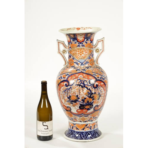 109 - A LARGE 19TH CENTURY IMARI BULBOUS VASE with polychrome coloured body and shaped side handles (54.5c... 