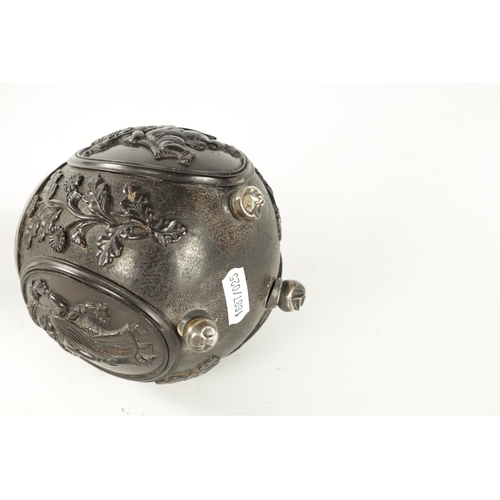 110 - AN 18TH CENTURY EASTERN SILVER METAL MOUNTED CARVED LIDDED COCONUT carved with oval panels of gods o... 