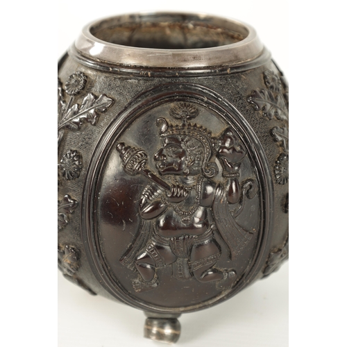 110 - AN 18TH CENTURY EASTERN SILVER METAL MOUNTED CARVED LIDDED COCONUT carved with oval panels of gods o... 