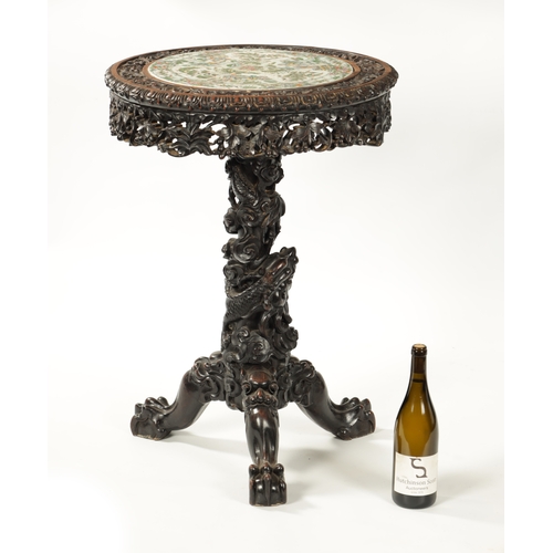 112 - A FINE 19TH CENTURY CHINESE PROFUSELY CARVED CENTRE TABLE WITH CANTONESE PORCELAIN INSET TOP the int... 